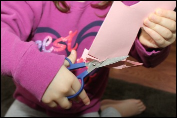 toddler cutting paper