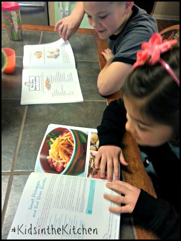 #kidsinthekitchen looking for new dinner ideas in cookbooks