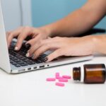 Close-up doctor using a laptop