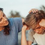 Free Woman in Blue Shirt Talking to a Young Man in White Shirt  Stock Photo