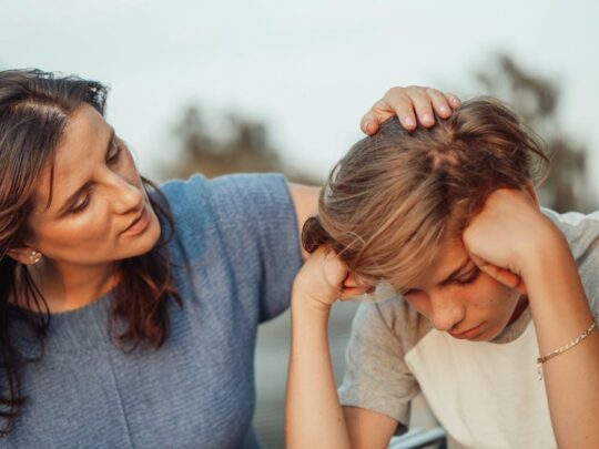 Free Woman in Blue Shirt Talking to a Young Man in White Shirt  Stock Photo