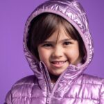 A young child wearing a purple coatAI-generated content may be incorrect.